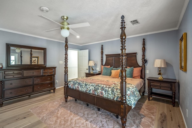 bedroom with visible vents, light wood finished floors, and baseboards