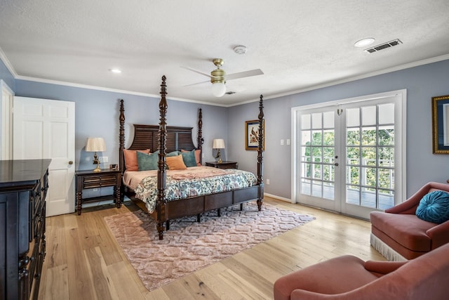 bedroom with crown molding, a textured ceiling, light wood finished floors, access to exterior, and visible vents