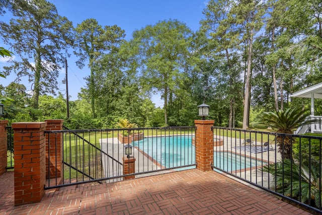 17003 Creeksouth Rd, Houston, TX 77068 - gate featuring a patio and view of scattered trees