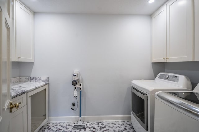 washroom with washer and dryer, baseboards, cabinet space, and recessed lighting