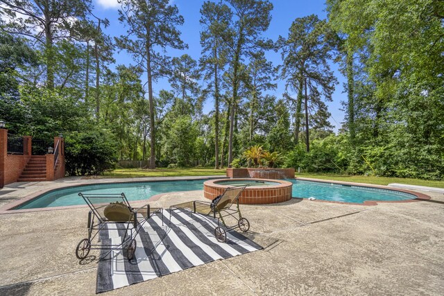 view of swimming pool with a pool with connected hot tub, a patio, stairway, and a diving board