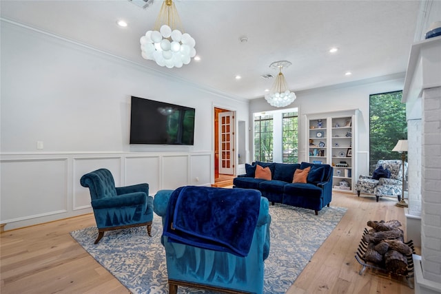 17003 Creeksouth Rd, Houston, TX 77068 - living area with a chandelier, crown molding, light wood-type flooring, a wainscoted wall, and recessed lighting