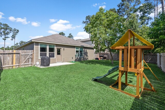 rear view of property featuring a playground, a patio area, and roof with shingles