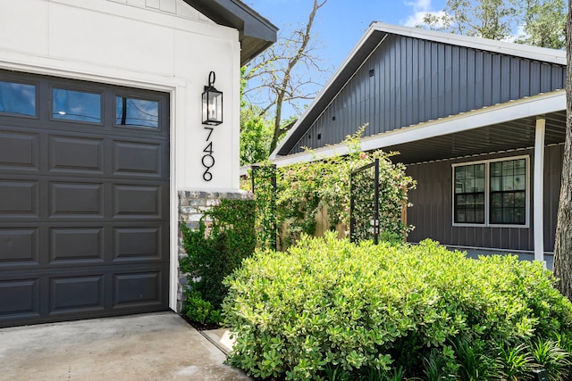 exterior space with board and batten siding and a garage