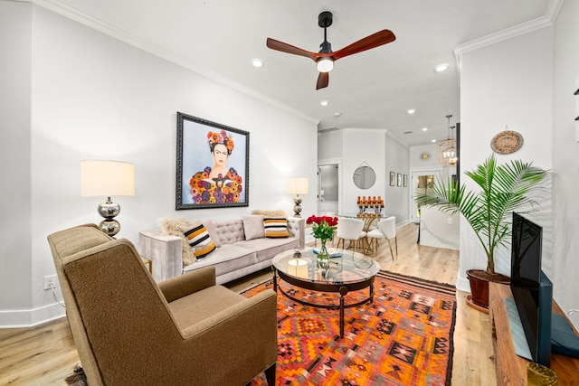 living area featuring recessed lighting, wood finished floors, a ceiling fan, ornamental molding, and baseboards