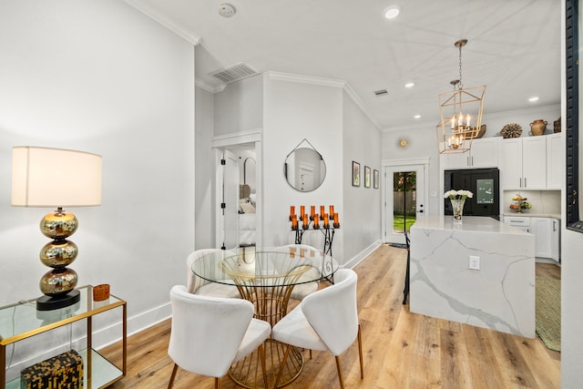 dining room with recessed lighting, crown molding, baseboards, and a notable chandelier