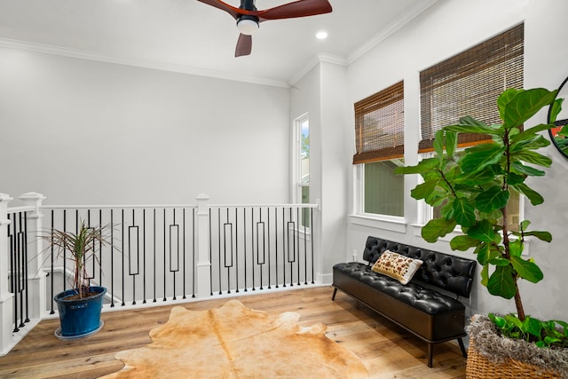 sitting room with ornamental molding, wood finished floors, recessed lighting, and ceiling fan