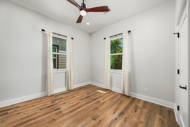 unfurnished room featuring recessed lighting, wood finished floors, baseboards, and ceiling fan