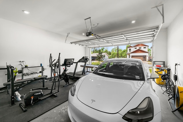 garage featuring a garage door opener and recessed lighting