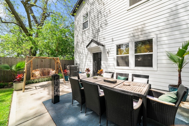 view of patio / terrace featuring outdoor dining space and fence