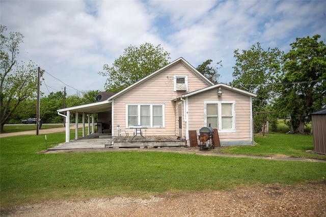 rear view of property featuring a lawn