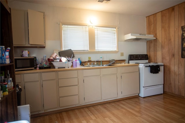 kitchen featuring white range with electric cooktop, a sink, light wood finished floors, stainless steel microwave, and under cabinet range hood