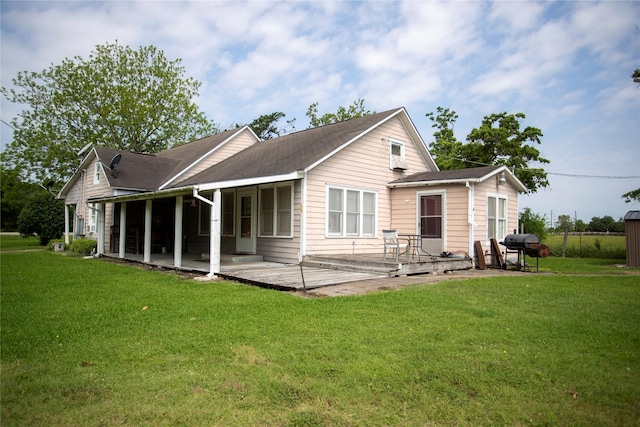 rear view of house featuring a lawn