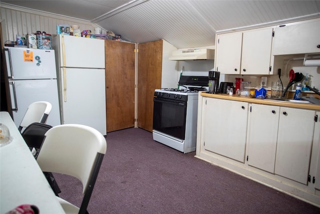 kitchen with under cabinet range hood, dark colored carpet, gas stove, and freestanding refrigerator