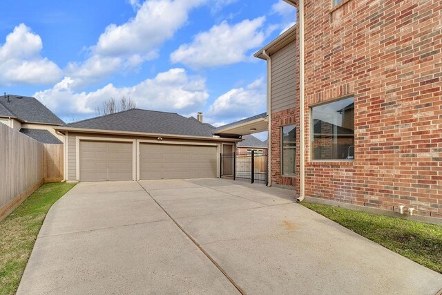 13811 Sugar Dock Ct, Houston, TX 77044 - view of patio featuring concrete driveway and an attached garage