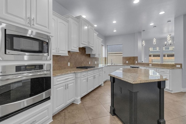 13811 Sugar Dock Ct, Houston, TX 77044 - kitchen with appliances with stainless steel finishes, light tile patterned floors, decorative backsplash, white cabinetry, and recessed lighting