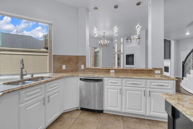 13811 Sugar Dock Ct, Houston, TX 77044 - kitchen with stainless steel dishwasher, a chandelier, white cabinetry, and light stone countertops