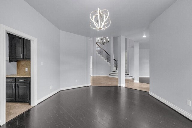 13811 Sugar Dock Ct, Houston, TX 77044 - unfurnished living room with a chandelier, wood finished floors, and stairs