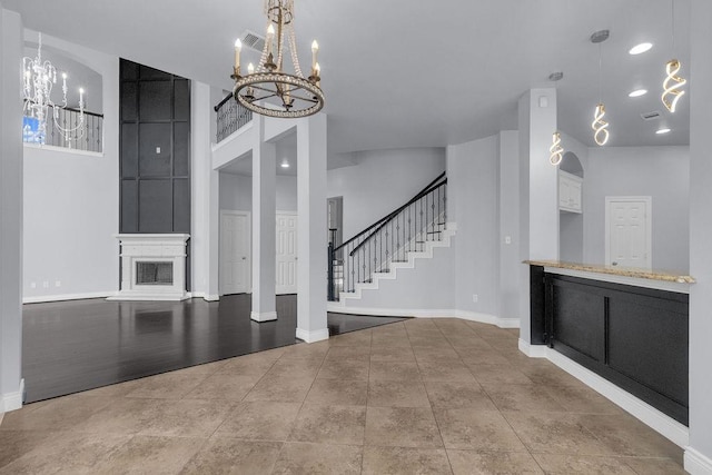 13811 Sugar Dock Ct, Houston, TX 77044 - interior space with a chandelier, stairway, a fireplace, and a towering ceiling