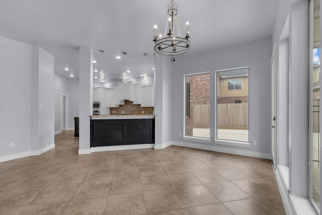 13811 Sugar Dock Ct, Houston, TX 77044 - kitchen featuring white cabinetry, a chandelier, recessed lighting, light countertops, and backsplash