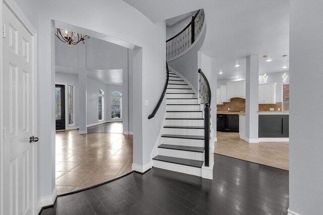 13811 Sugar Dock Ct, Houston, TX 77044 - entrance foyer with a chandelier, stairs, wood finished floors, and recessed lighting