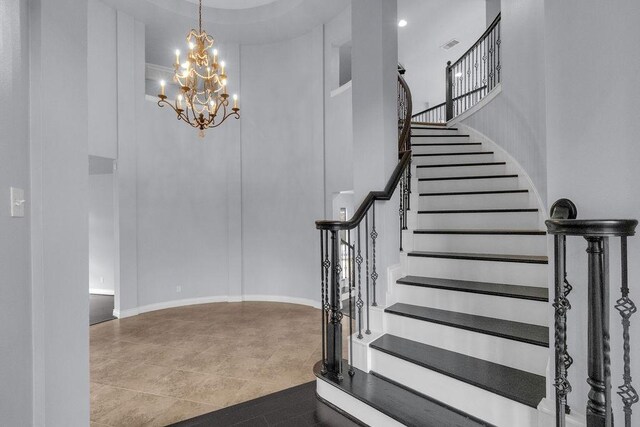13811 Sugar Dock Ct, Houston, TX 77044 - staircase featuring a towering ceiling, a chandelier, and tile patterned floors