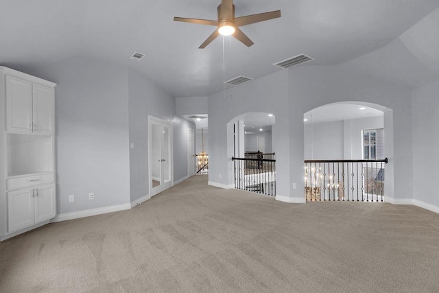 13811 Sugar Dock Ct, Houston, TX 77044 - empty room with ceiling fan, light colored carpet, vaulted ceiling, a chandelier, and arched walkways