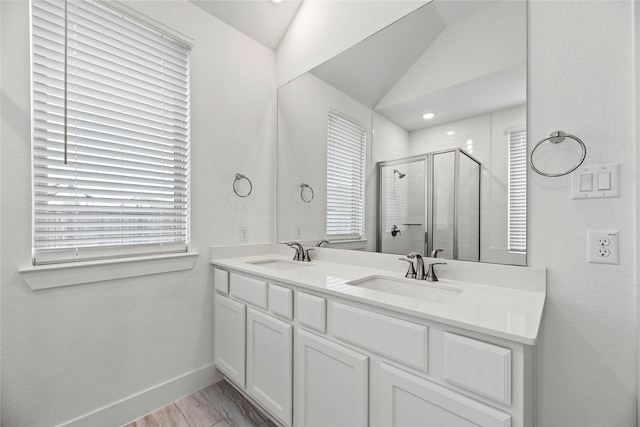 18402 Mesquite Flats Trl, Cypress, TX 77433 - bathroom with a stall shower, double vanity, baseboards, and vaulted ceiling