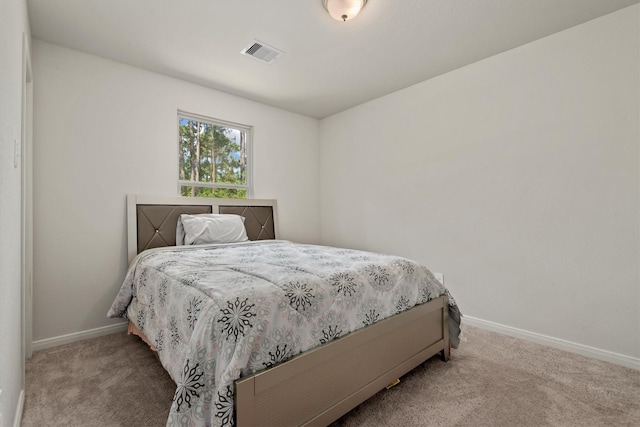 bedroom featuring baseboards, carpet flooring, and visible vents