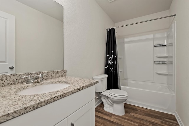 bathroom featuring wood finished floors, vanity, baseboards, toilet, and shower / bath combo with shower curtain