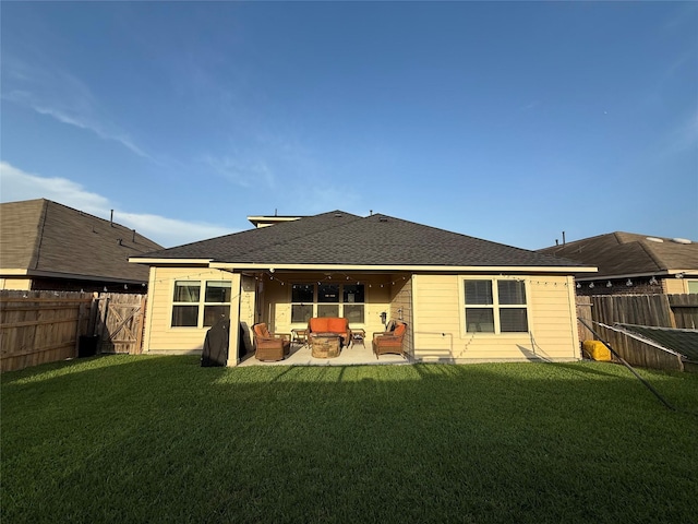 rear view of house featuring a fenced backyard, outdoor lounge area, and a yard