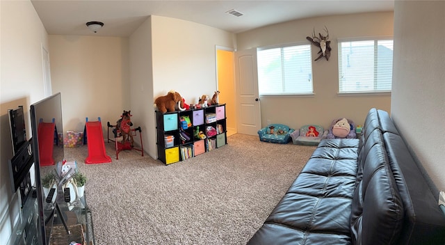 recreation room featuring carpet and visible vents