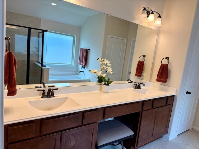 full bathroom with tile patterned floors, a sink, a shower stall, and double vanity