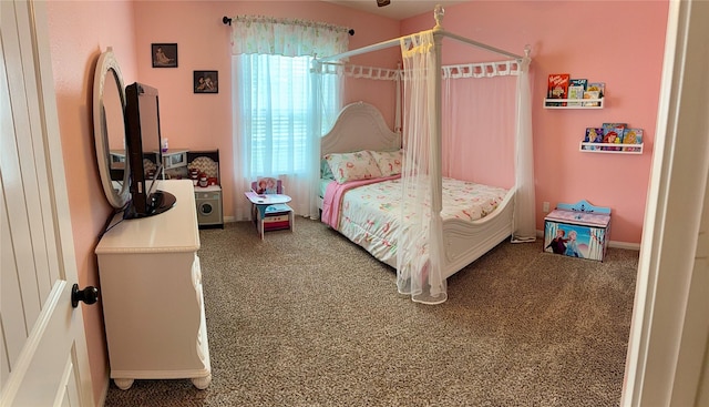 carpeted bedroom featuring baseboards