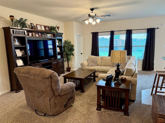 living room featuring baseboards, a ceiling fan, and carpet