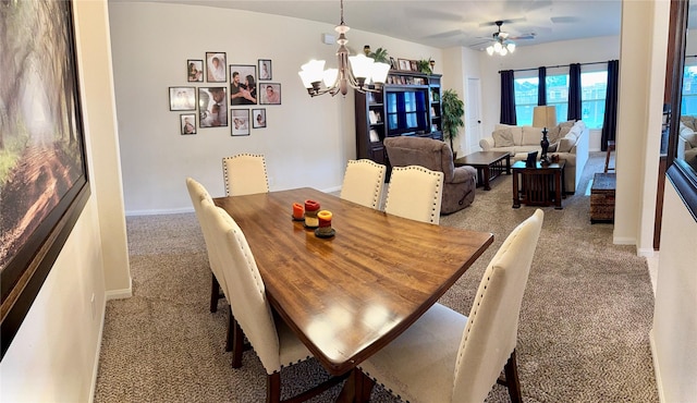 dining area with ceiling fan with notable chandelier, light carpet, and baseboards