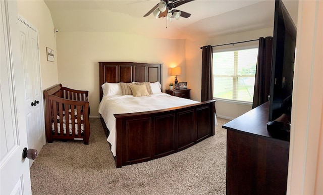 bedroom featuring light colored carpet, ceiling fan, lofted ceiling, and baseboards