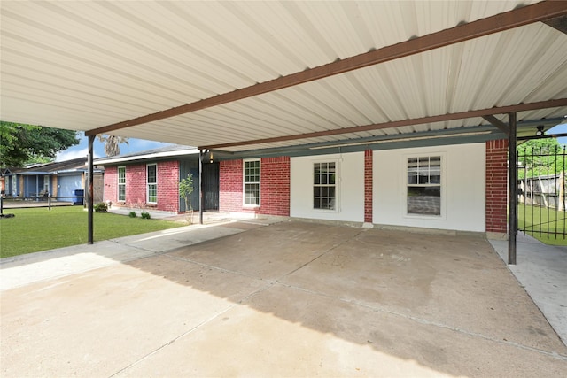 view of patio / terrace featuring fence and a carport