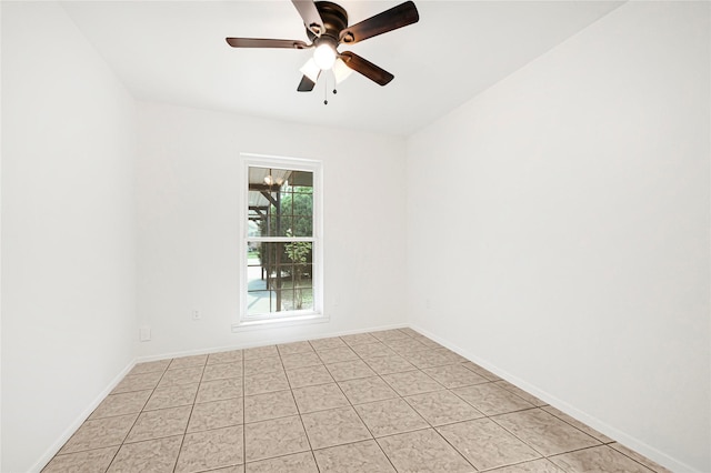 spare room with baseboards and a ceiling fan