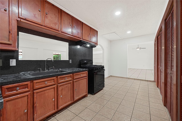 kitchen featuring decorative backsplash, black gas stove, a sink, and a textured ceiling