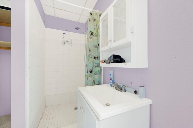 full bathroom featuring vanity and tiled shower