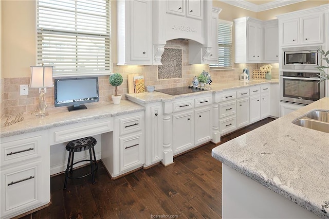 kitchen featuring white cabinets, stainless steel appliances, dark wood-style floors, and ornamental molding