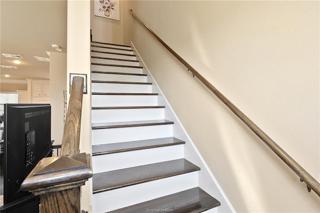 stairway featuring visible vents
