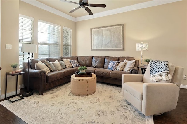 living room featuring crown molding, baseboards, a ceiling fan, and wood finished floors