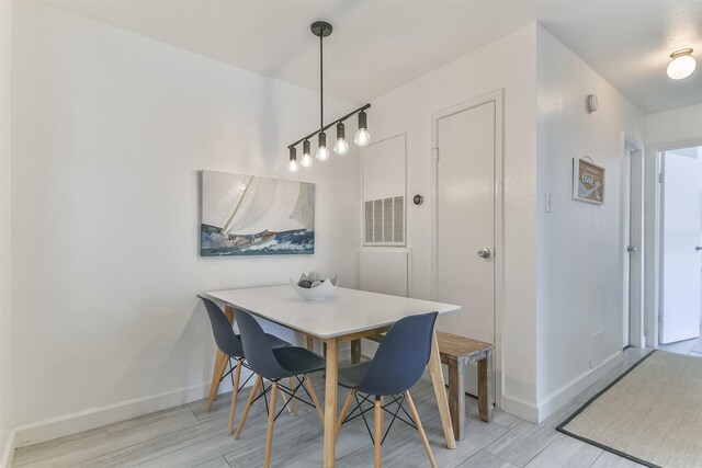 dining room with visible vents, baseboards, and light wood-style floors