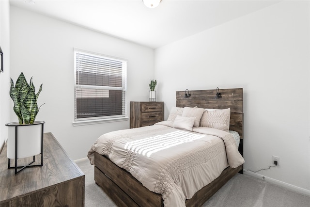 bedroom featuring baseboards and carpet