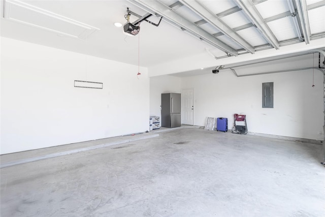garage with a garage door opener and electric panel
