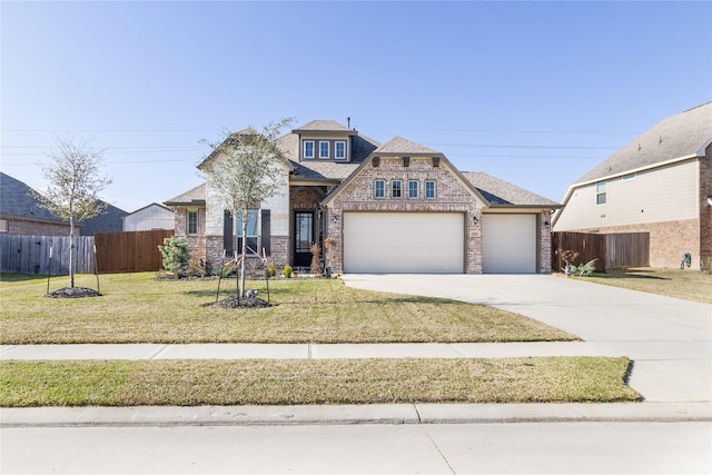 craftsman inspired home featuring fence, driveway, brick siding, and a front yard