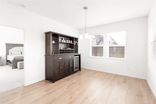unfurnished dining area with light wood finished floors and baseboards