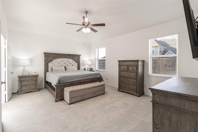 bedroom featuring ceiling fan, baseboards, and light carpet